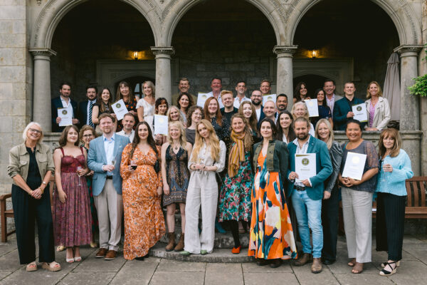 A large group of people holding award certificates